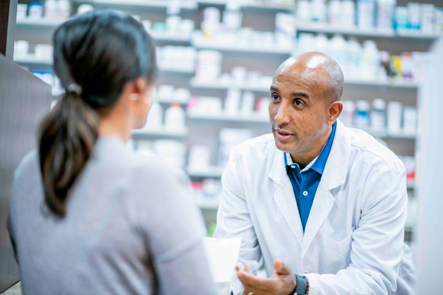 Pharmacist consulting with a patient at an independent pharmacy