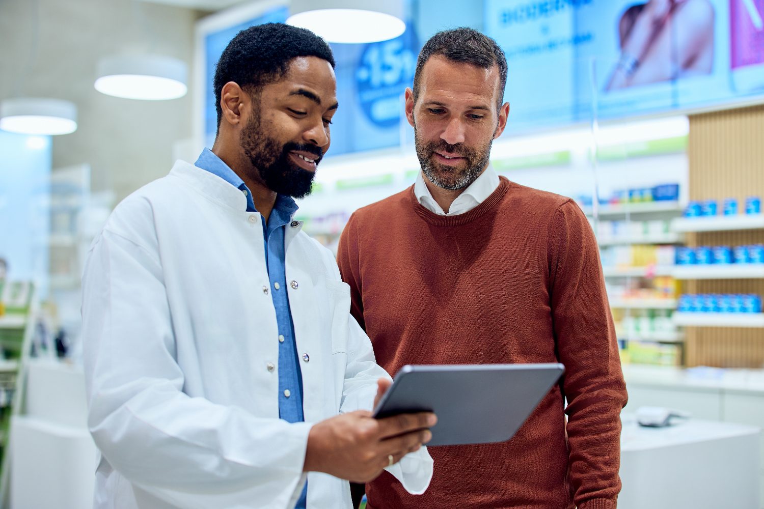 Pharmacist consulting with patients